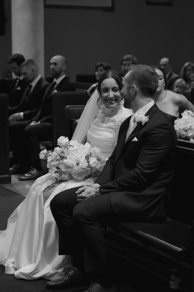 A Catholic Bride and Catholic Groom glance at each other during their Catholic Wedding Mass