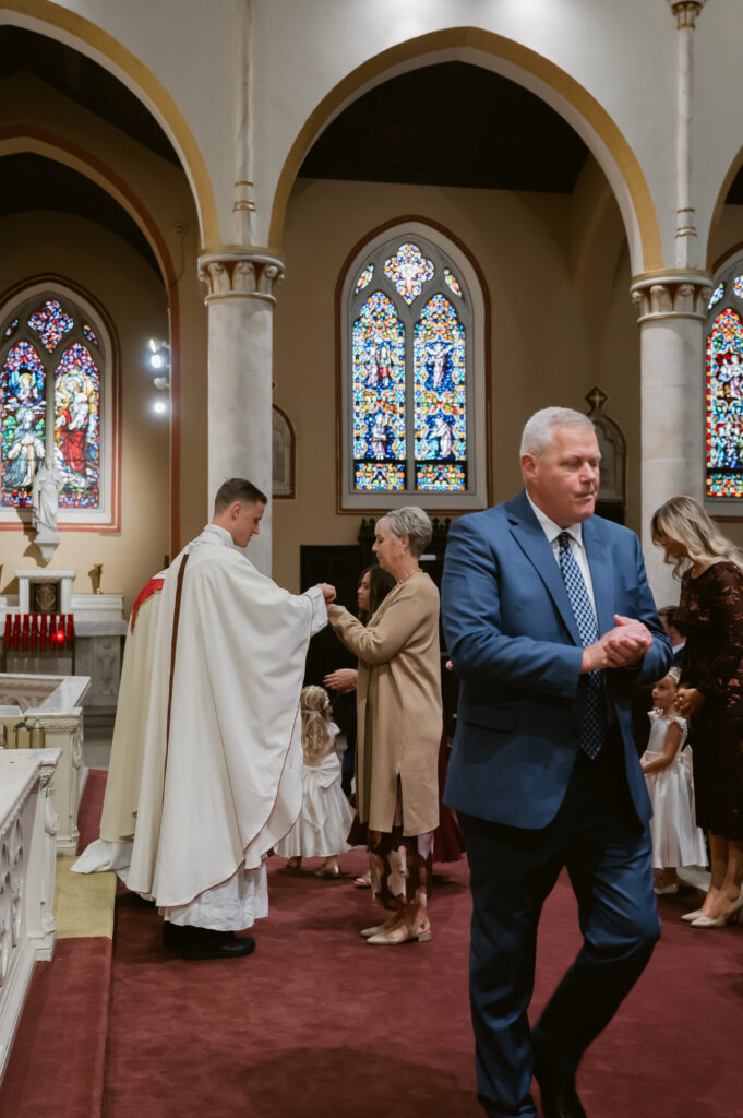 A Priest distributes Holy Communion during a Catholic Wedding Mass in Ohio