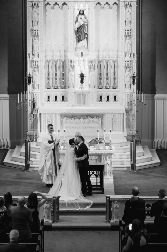 A Catholic Bride and a Catholic Groom share their first kiss during a Catholic Wedding Mass in Ohio. 