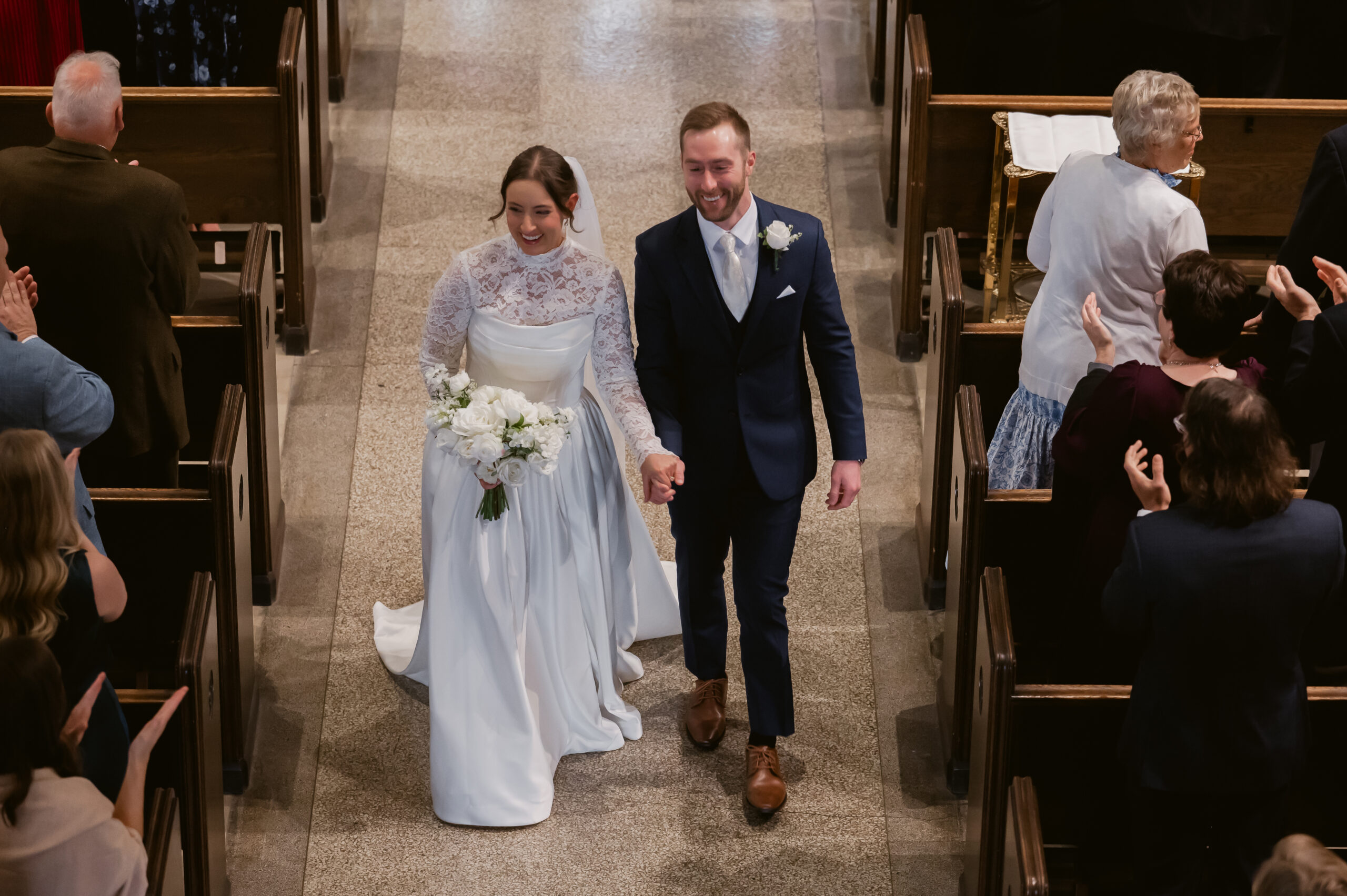 A Catholic Bride and Groom Walk down the aisle at their Catholic Wedding Mass in Ohio