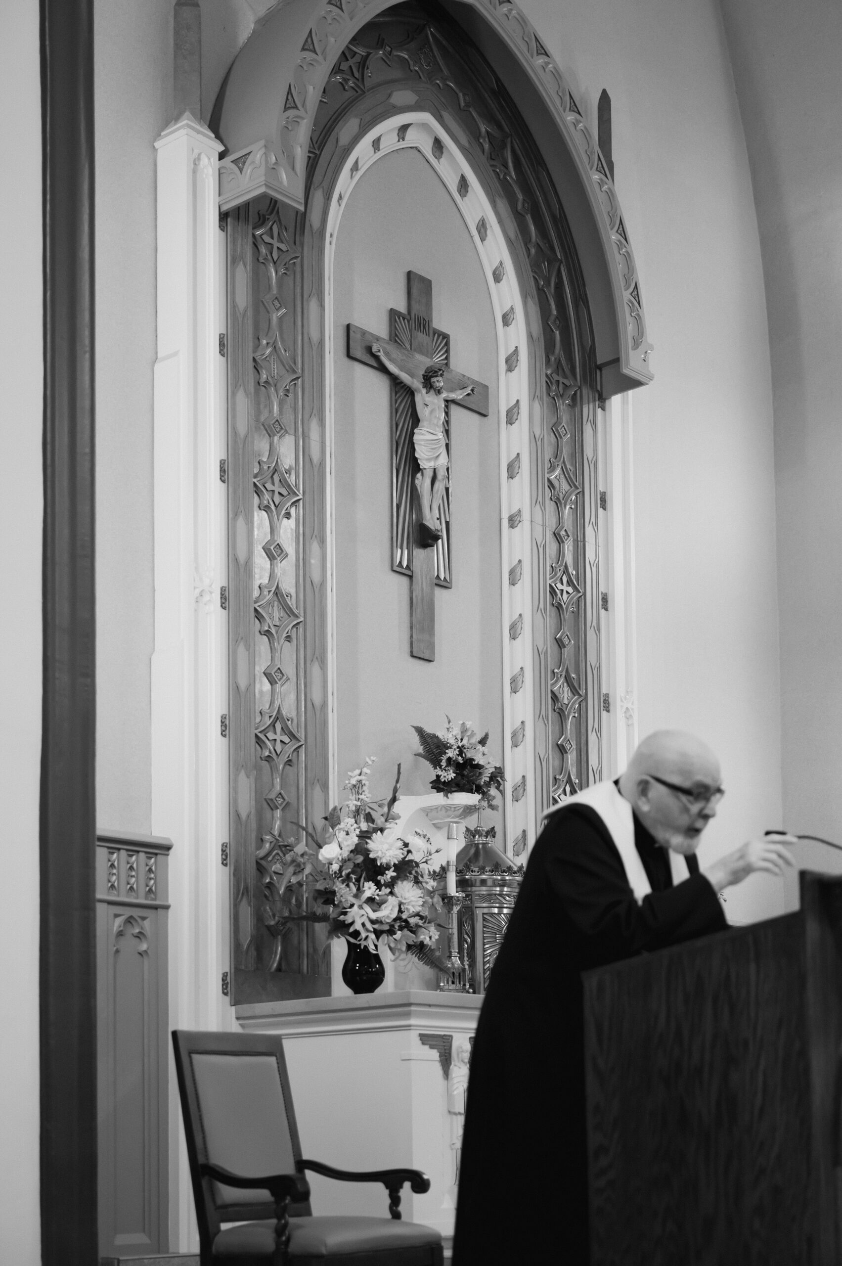 A Catholic priest gives a homily under a crucifix during a Catholic Wedding Mass in Ohio