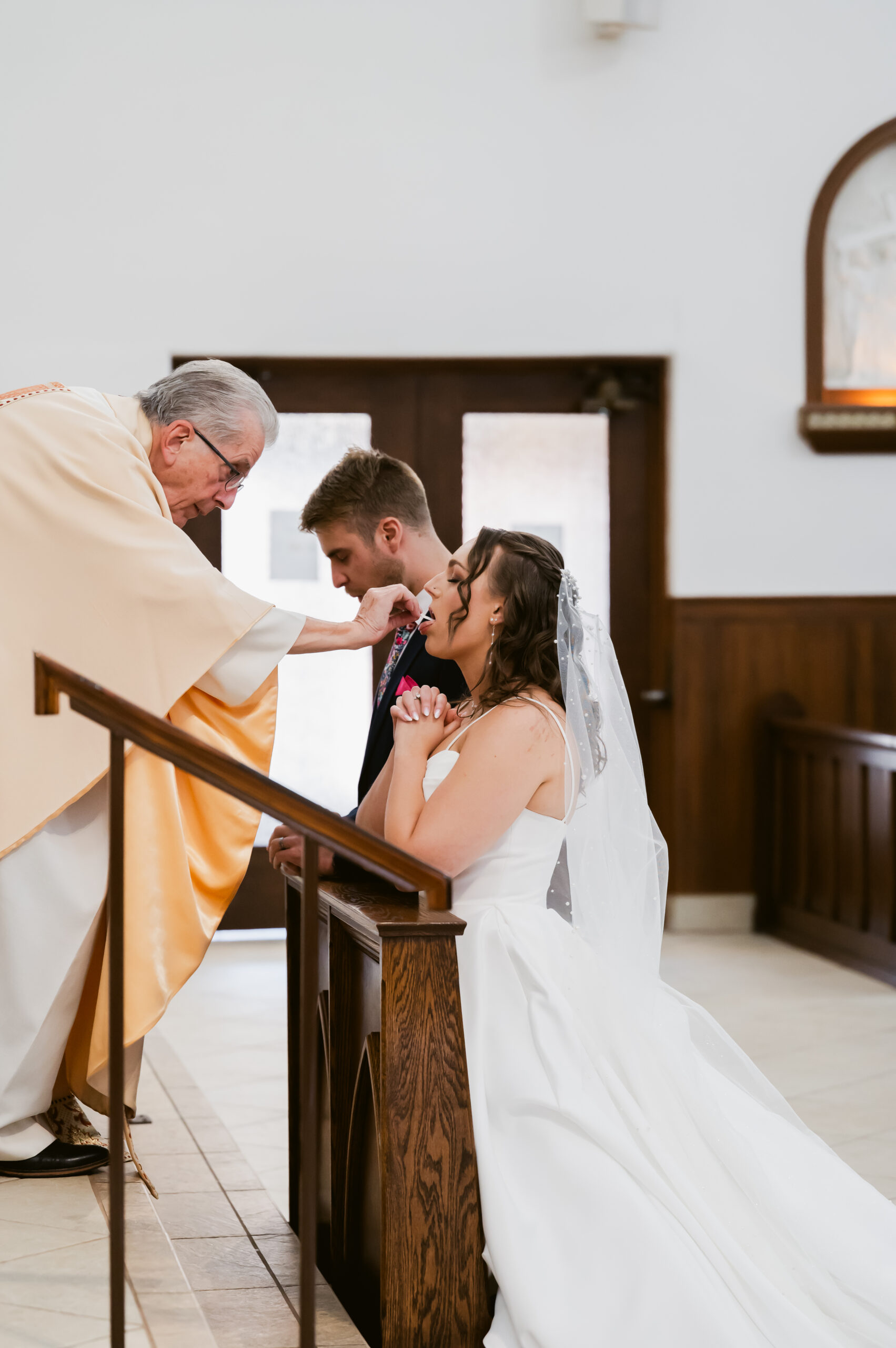 A Catholic Bride receives the Eucharist during a Catholic Wedding Mass in Ohio. 